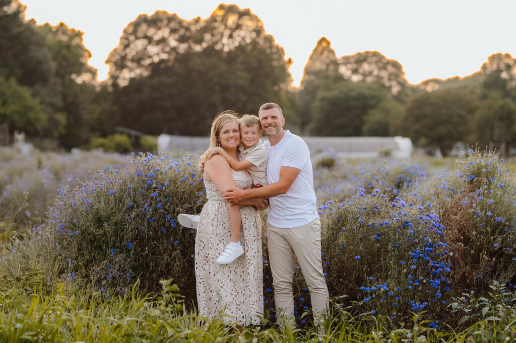 Family standing together in wildflower field at Wildly Native Flower Farm