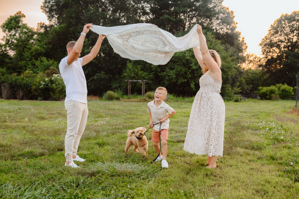 Family playing blanket game in open field