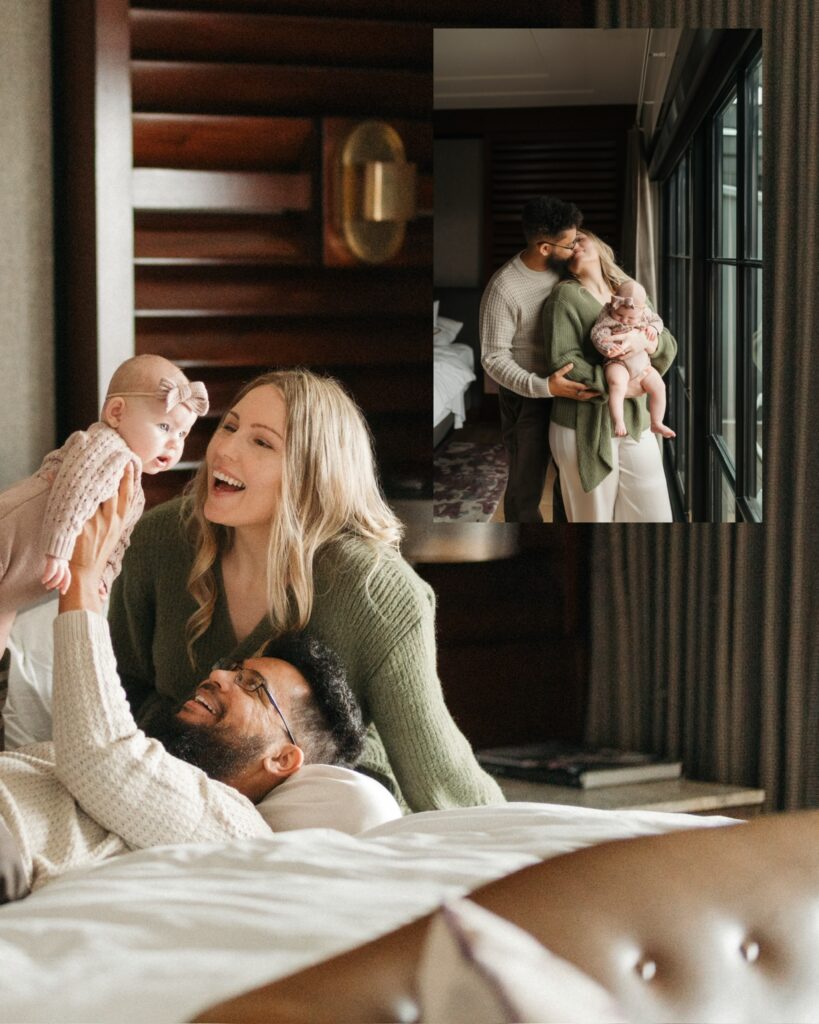 dad is laying on the bed holding his daughter up like an airplane, resting his head on mom's leg, who is sitting up and smiling brightly at her daughter.