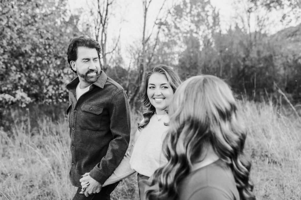 side view of family of 3 walking together 