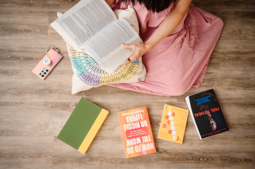 Detail shot by Annapolis MD brand photographer showing therapist holding DSM-5 and healing books