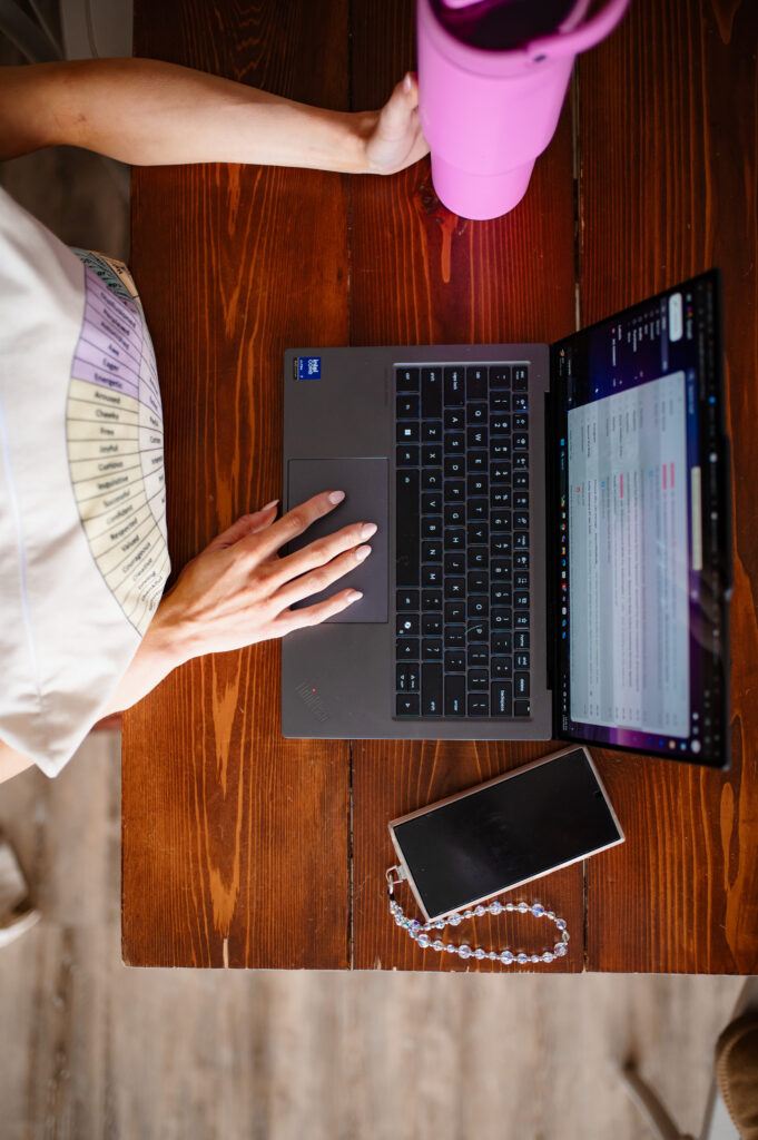 Annapolis brand photographer captures therapist workspace flatlay with laptop and emotions wheel