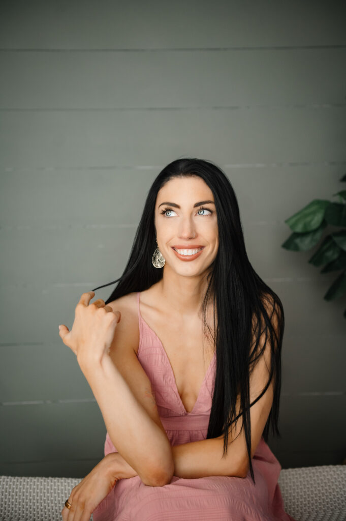 Brand photographer in Annapolis MD portraits female entrepreneur in pink dress during brand session