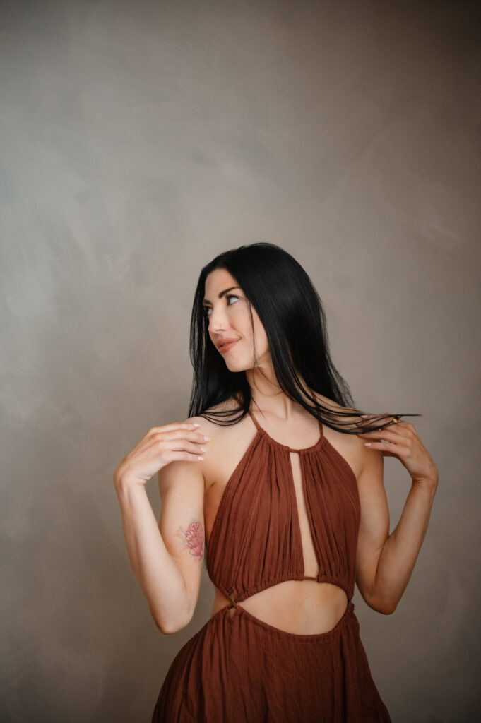 Studio portrait by Annapolis MD brand photographer of female entrepreneur in rust halter dress