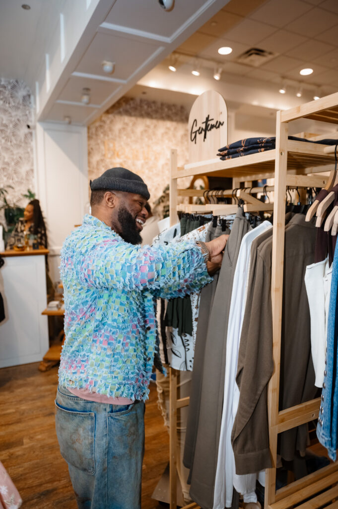 Photographer snaps an image of a Guest browsing the Gentlemen's rack at Bohemian Black during the Hello Spring fashion show event in Annapolis