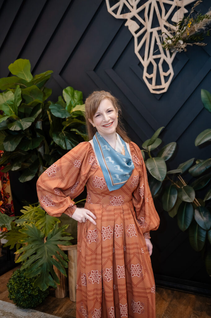 Model in a rust orange printed maxi dress with silk scarf styled by Bohemian Black for the Hello Spring fashion show